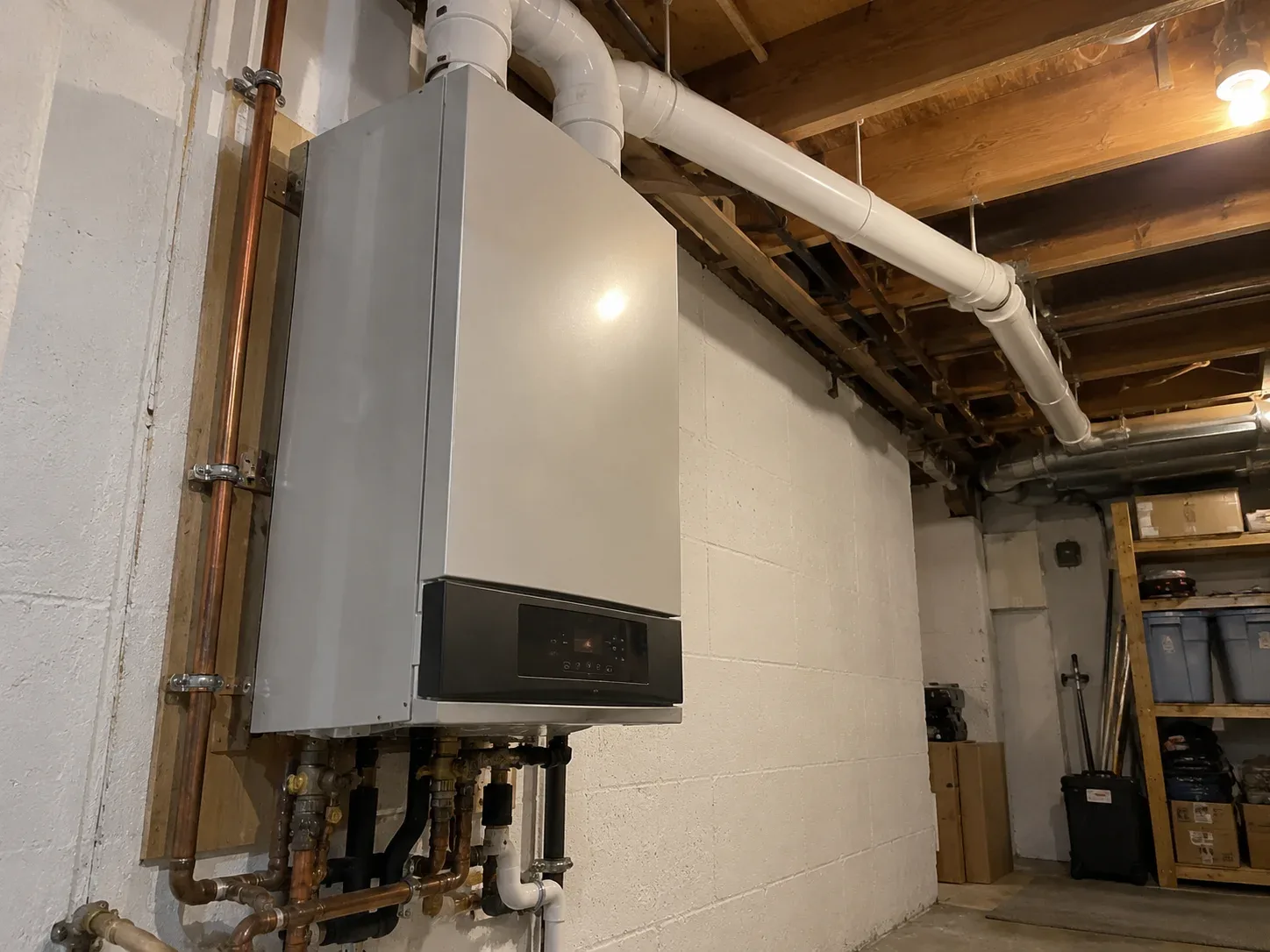 High-efficiency wall-mounted condensing boiler with PVC venting in a Hamilton home